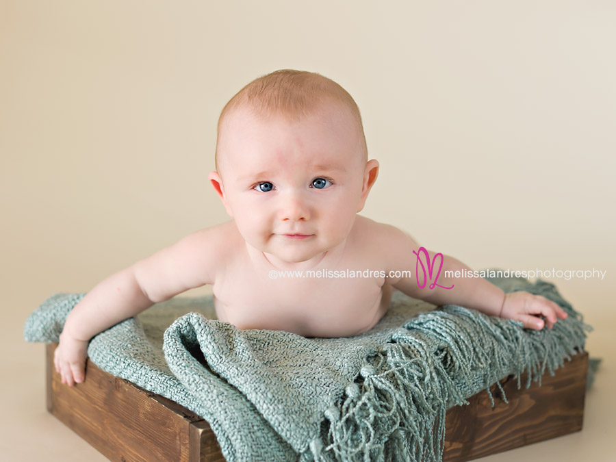 four month old baby boy on wood box prop at his photo session