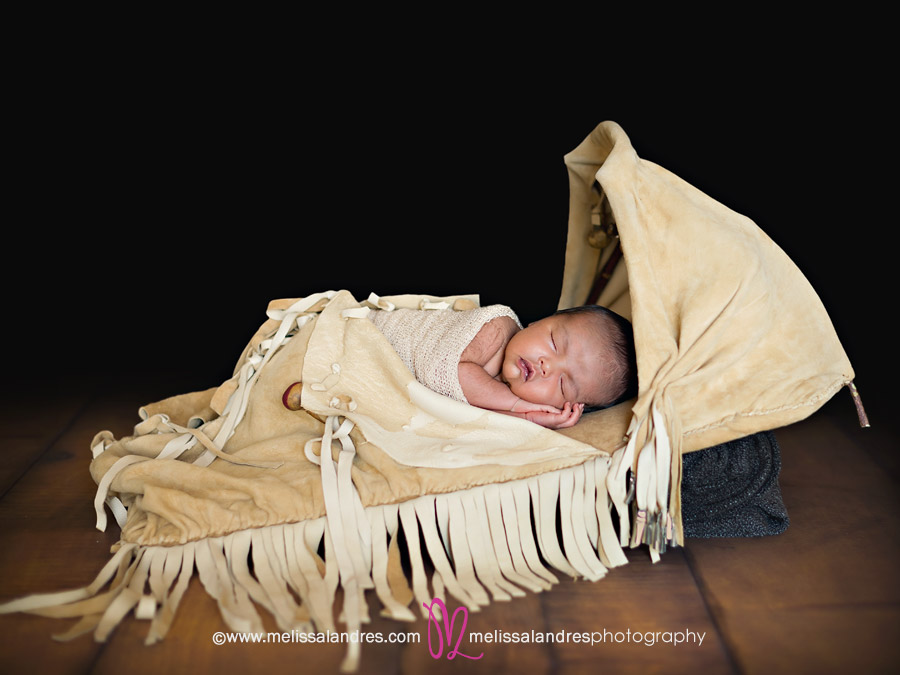 Baby boy in handmade Native American baby carrier by Newborn photographer Melissa Landres