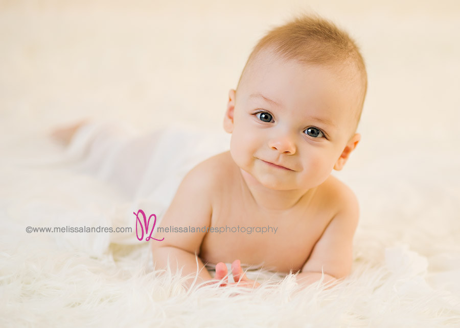 Cute baby boy, smiling baby photos on white fur rug