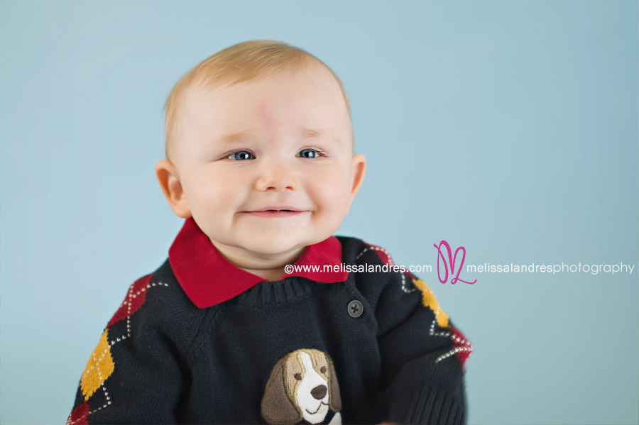 cute little 8 month old happy baby boy with doggie sweater