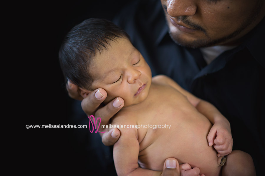 Dad holding his newborn son