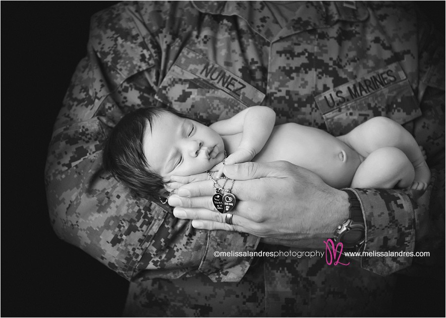 US Marine daddy with newborn daughter in his arms by La Quinta baby photographer Melissa Landres