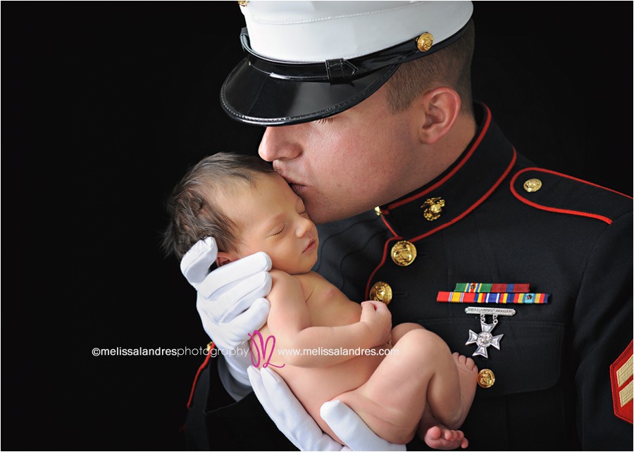 Marine baby, Daddy in Marine uniform kissing newborn baby by La Quinta phtoographer Melissa Landres