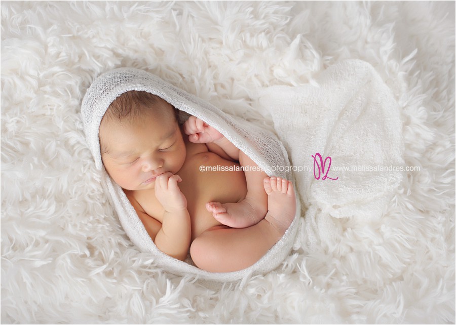 baby on dreamy white fur rug, cocoon wrap, newborn baby as art