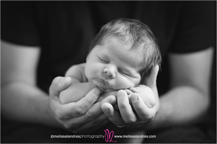 daddy's hands holding baby black and white newborn photos