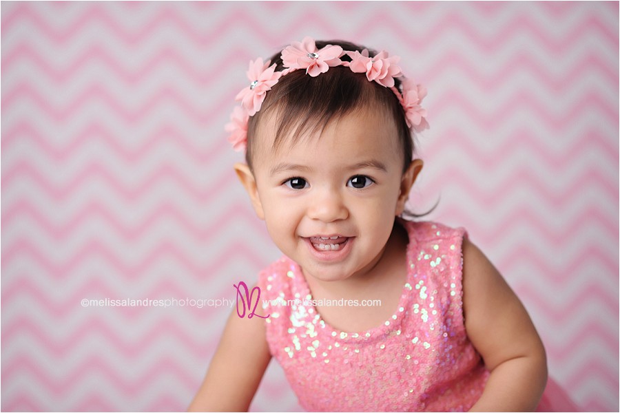 baby's first birthday photo shoot, cute baby girl with pink glitter dress with pink chevron