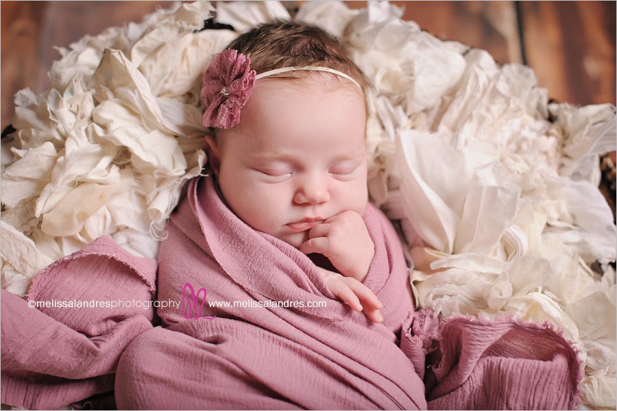 newborn baby portraits, baby in basket, rose colored wrap and headband