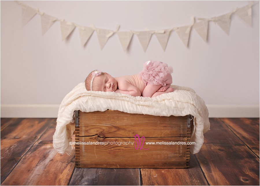 adorable newborn baby props, cute baby sleeping on wooden box wearing pink ruffle bloomers