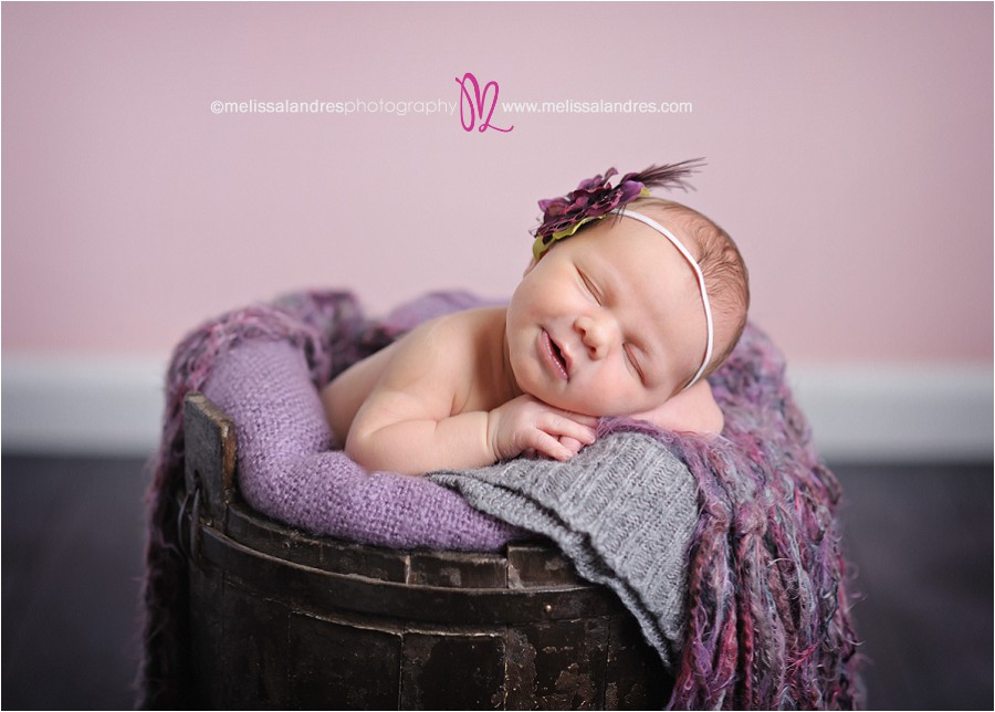 baby in vintage wooden bucket, pink and purple, flower headband, newborn baby girl smiling, la quinta baby photos