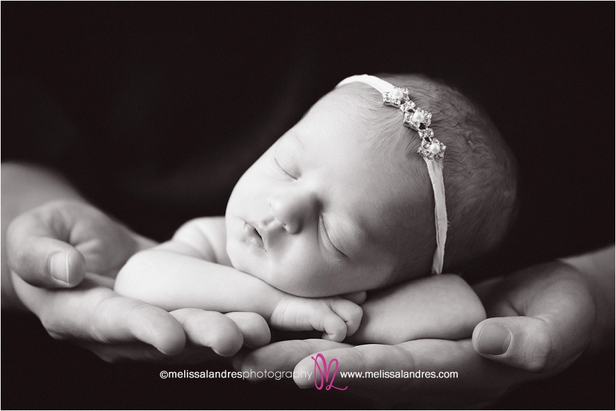 holding baby daughter in his hands Newborn-baby-photos-Indio-Melissa-Landres-photograpy