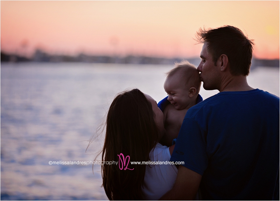 sunset silhouette family photo session with 7 month old baby on the beach in San Diego