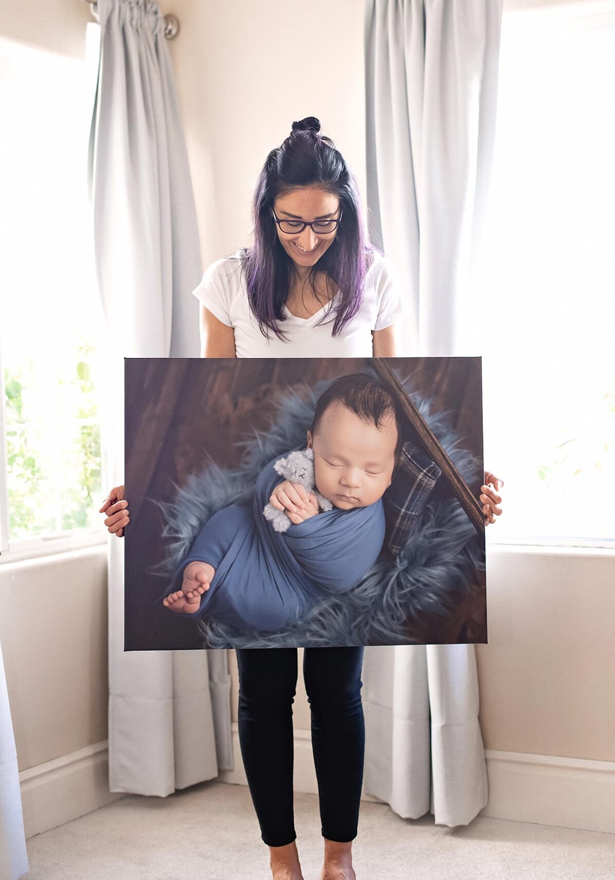 Coachella Valley Newborn baby photographer Melissa Landres with printed canvas of new baby 